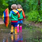 little-boy-and-girl-walking-on-rainy-day-bright-colours-great-Fotor